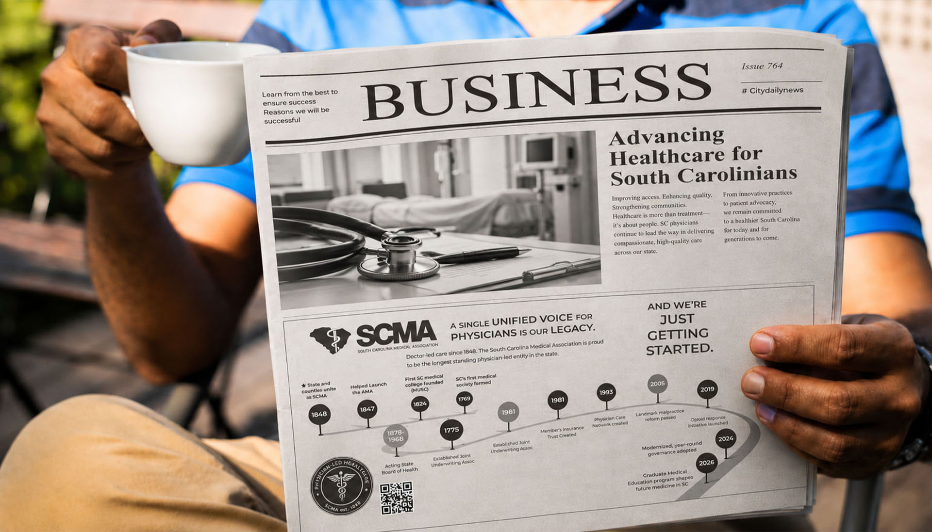 Reader holding a newspaper business section featuring an SCMA advertisement on advancing healthcare