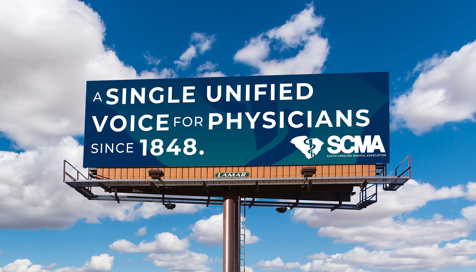SCMA billboard against a blue sky reading A Single Unified Voice for Physicians Since 1848